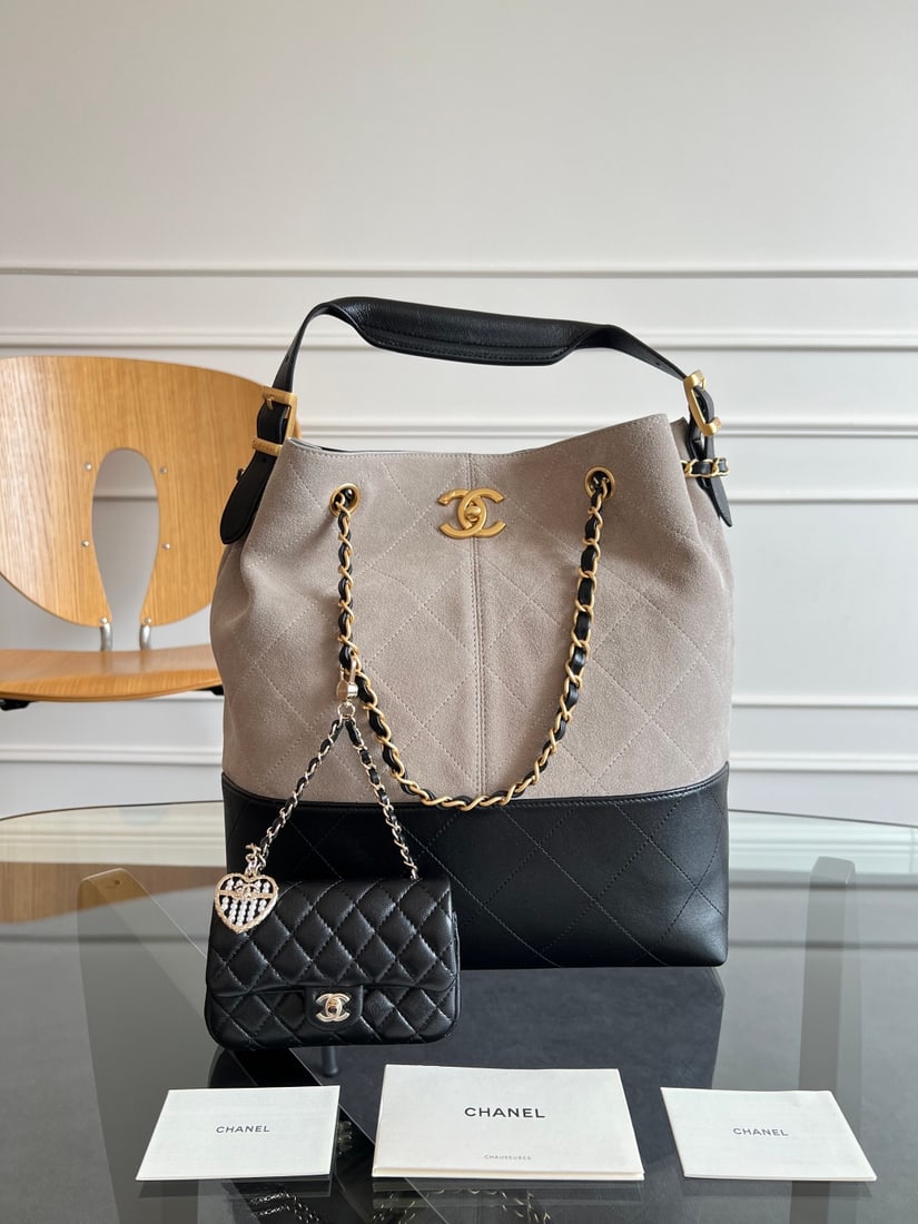 CHANEL: This CHANEL Metiers d'Art bag, crafted from calfskin, draws inspiration from Coco Chanel's ebony lacquered screen. The iconic quilted pattern and unique color-blocking design create a luxurious feel