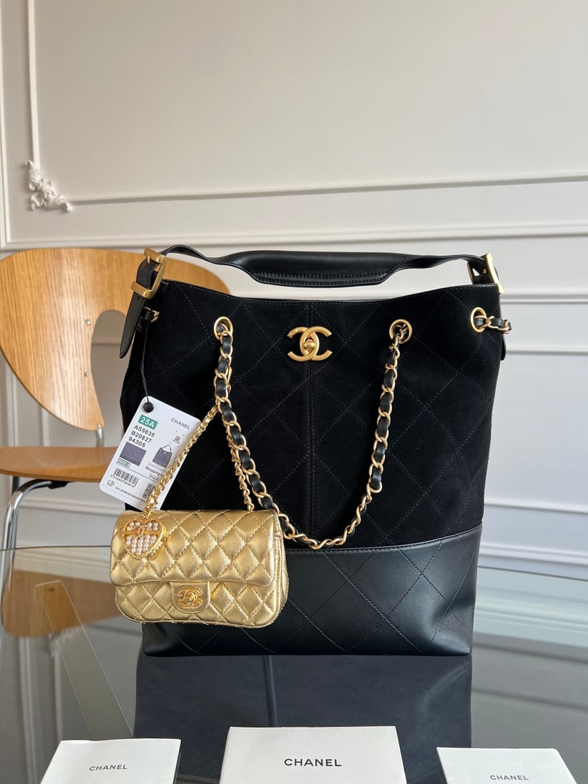 CHANEL: This CHANEL Metiers d'Art bag, crafted from calfskin, draws inspiration from Coco Chanel's ebony lacquered screen. The iconic quilted pattern and unique color-blocking design create a luxurious feel t