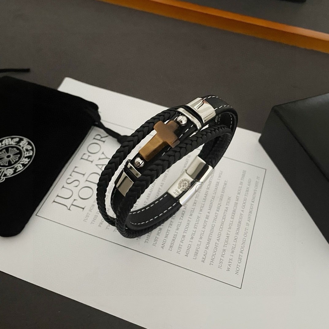 Chrome Hearts Tiger Eye Cross Leather Cord Bracelet: The Chrome Hearts Tiger Eye Cross Leather Cord Bracelet features a unique design with embossed patterns and distinctive styles. The cross and scout flower are Chrome Hearts' signature elements, making