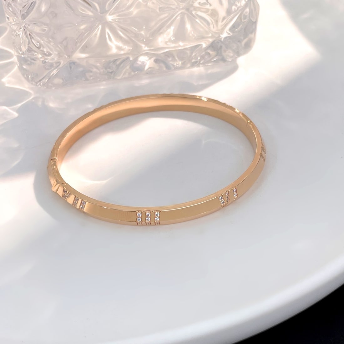 Atlas series narrow X bracelet: The Atlas series' narrow X shaped bracelet features Roman numerals engraved on it, symbolizing the importance of time. Wearing it exudes a sense of sophistication, with the engraved Roman numerals con