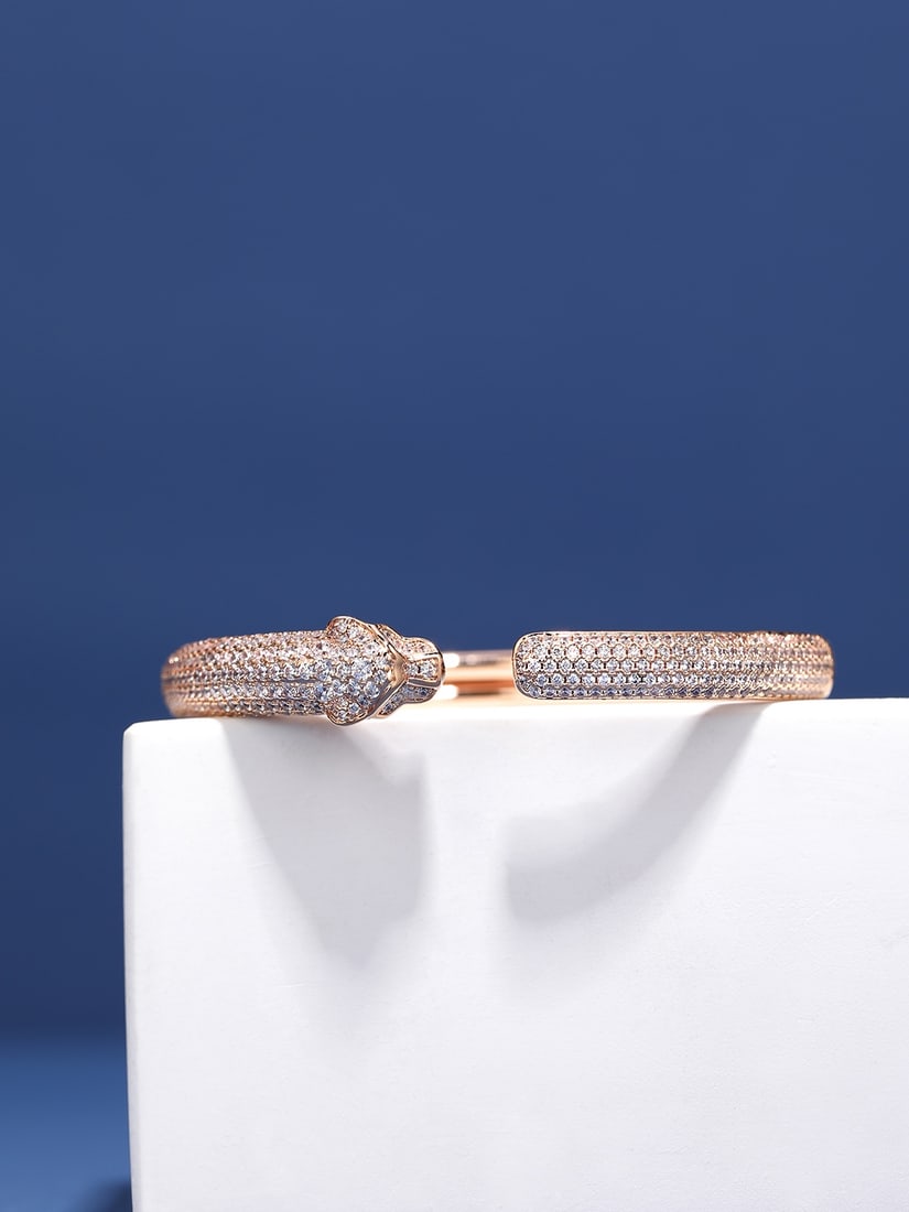 PanthEre de Cartier Panther Bracelet: The Panthee de Cartier bangle features sparkling diamonds shimmering on its rose gold surface, exuding a dazzling, jewel like beauty. One end boasts a simple, lustrous metallic finish, while the other
