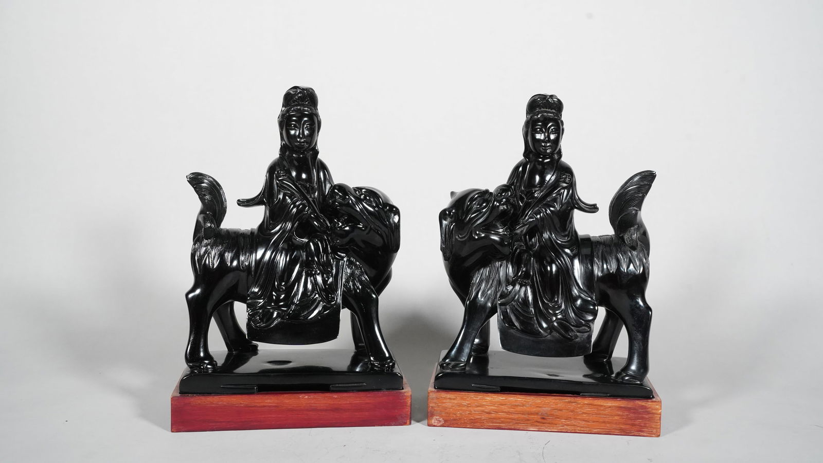 A Pair of Chinese Cherry Amber Carved Statue in Figures of Guanyin Sitting on Lion (1 of 6)