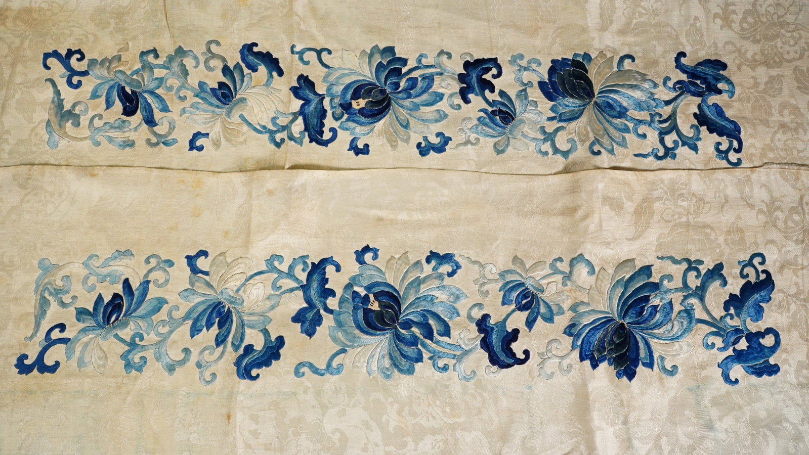 Pair of Classic Blue & White Flower Embroideries: A Pair of Classic Blue & White Flower Embroideries. Size: 34"L x 8". Good condition with stains.
