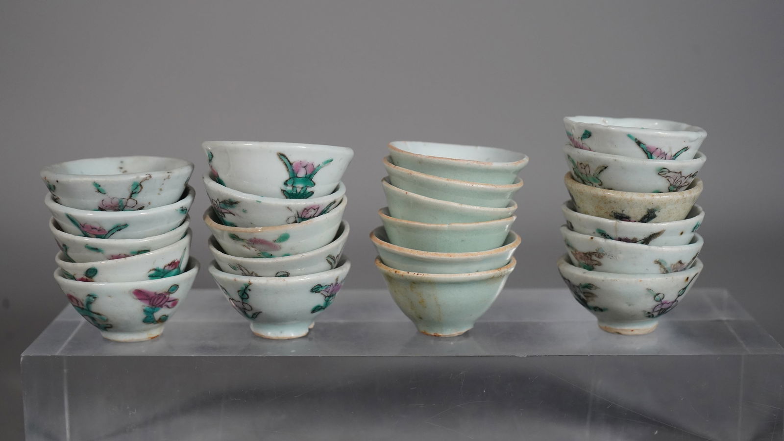 Group of 22 Old Chinese Famille Rose & Celadon Porcelain Mini Rice Wine Cups: Group of 22 Old Chinese Famille Rose & Celadon Porcelain Mini Rice Wine Cups. Measure approx. 1"3/4Dia x 3/4"H. In good condition for its age, just few small chips at the rim.(Stand Not Included)