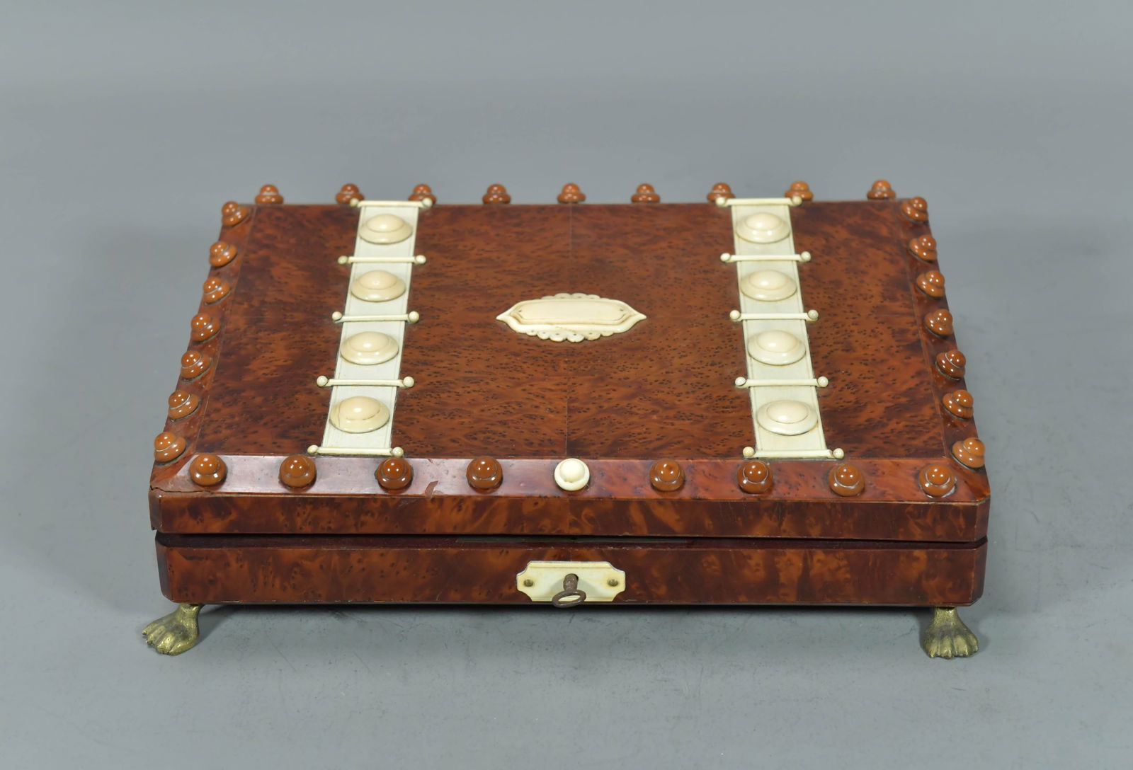 Vintage Burl Wood Storage Box w/Bone Carving Inlay: Vintage Burl Wood Storage Box w/Bone Carving Inlay. The box has a rich burl wood finish and stands on ornate feet. This box are used for storing bone made dominoes. 12"L x 9"W x 2"1/2H; General In goo