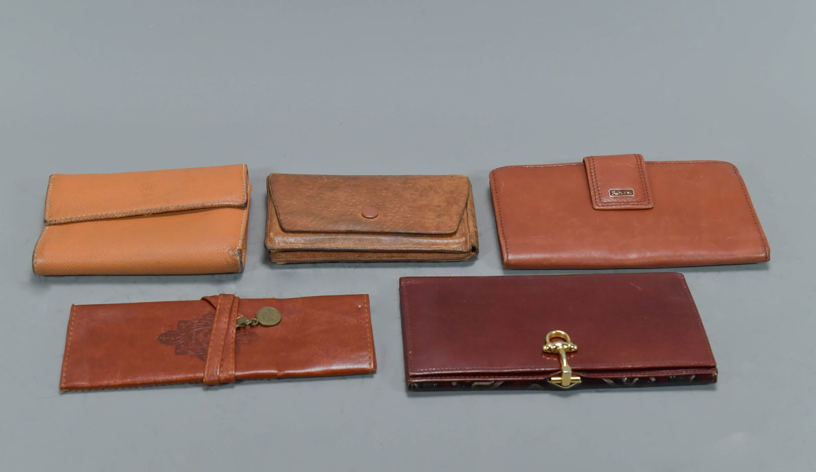 Group of 5 Vintage Genuine Leather Wallets.: Group of 5 Vintage Genuine Leather Wallets. 1) Viking Real Pigskin Cigarette ? Holder, Made in England, 5"1/2L x 3"3"1/4W; 2) Rolex logo royal yellow leather wallet, 5"1/2 x 4"; 3) ROLFS genuine leath