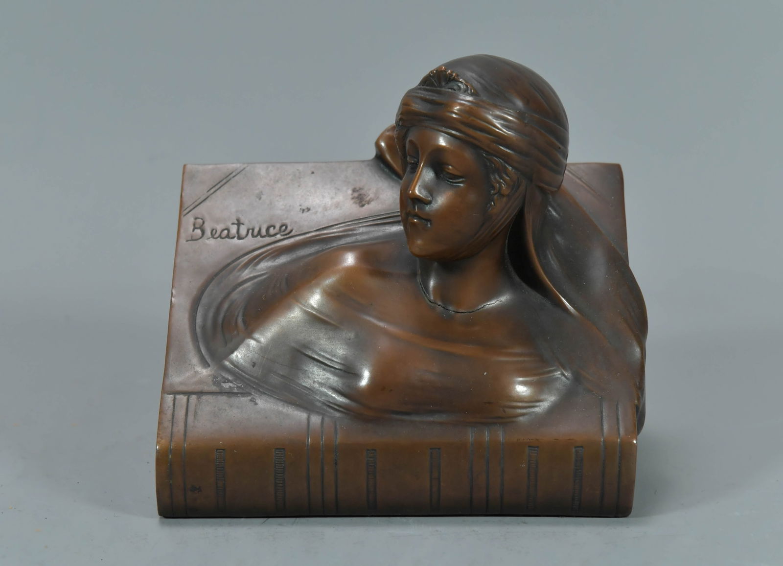 Antique Bronzed Bookend Depicting A Bust of Beatrice: Antique Bronzed Bookend Depicting A Bust of Beatrice. A central figure in /Dante Alighieri's The Divine Comedy. 6"L x 3"3/4W x 5"1/2H; In good condition, (Stand Not Included)