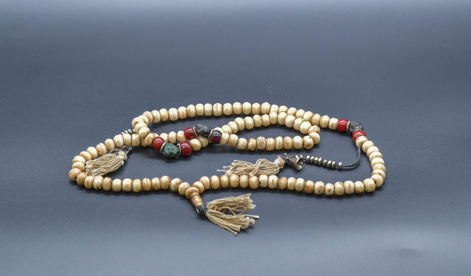 Old Tibetan Yak Bone Buddhist Prayer Beads w/Red & Green Accent Beads: Old Tibetan Yak Bone Buddhist Prayer Beads w/Red & Green Accent Beads. Total 118 beads, 10mm, length 18"; In good condition, (Stand Not Included)