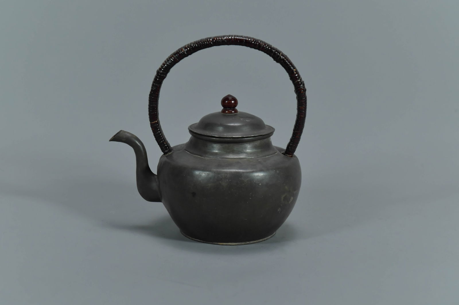 Marked Antique Japanese Pewter Teapot w/Woven Handle: Marked Antique Japanese Pewter Teapot w/Woven Handle. Measures approx. 4"H x 5"1/2W; In good condition, (Stand Not Included)