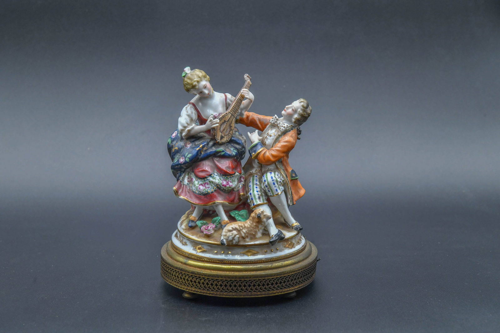 Antique Dresden-Style Porcelain Figure Music Box: Antique Dresden-Style Porcelain Figure Music Box. 7"1/2H x 5"1/2W; The woman's head has been repaired, and one of her fingers was missing; Antique condition.