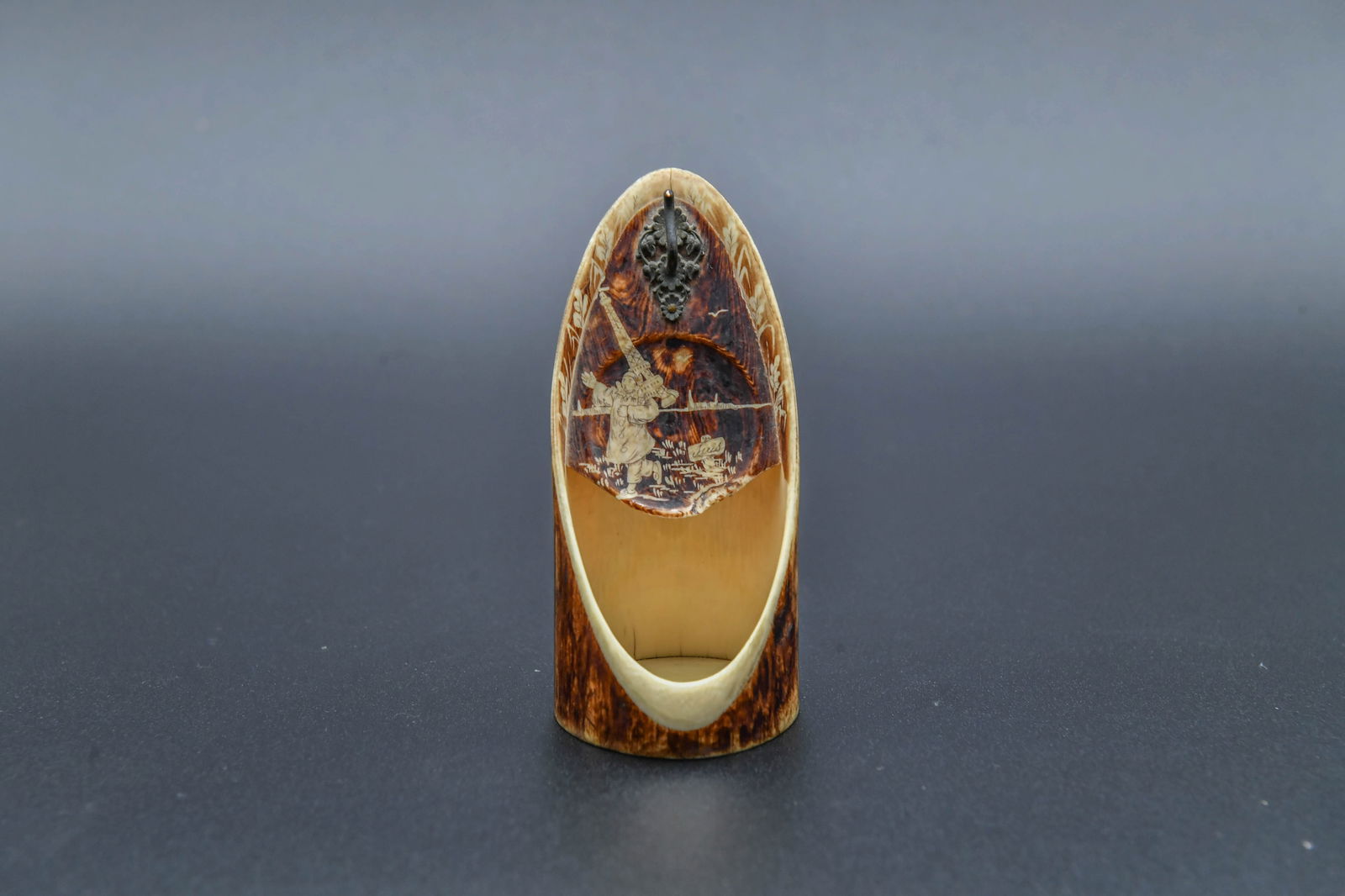 Fine Antique French Handmade Bone Carved Pocket Watch Display Holder: Fine Antique French Handmade Bone Carved Pocket Watch Display Holder. The artwork depicts a figure carving the Eiffel Tower over his shoulder. 4"H x 2"W; In good condition.