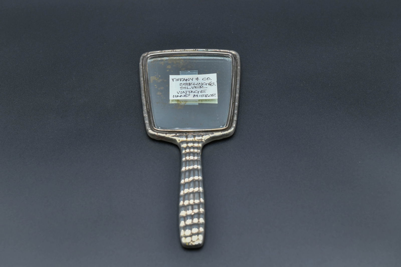 Vintage Tiffany & Co. Sterling Silver Hand Mirror 25250: Vintage Tiffany & Co. Sterling Silver Hand Mirror 25250. Measures approx. 10"1/2L x 4"1/4W; In good overall condition, with some signs of aging on the mirror. Total weight: 344.1g, (Stand Not Included