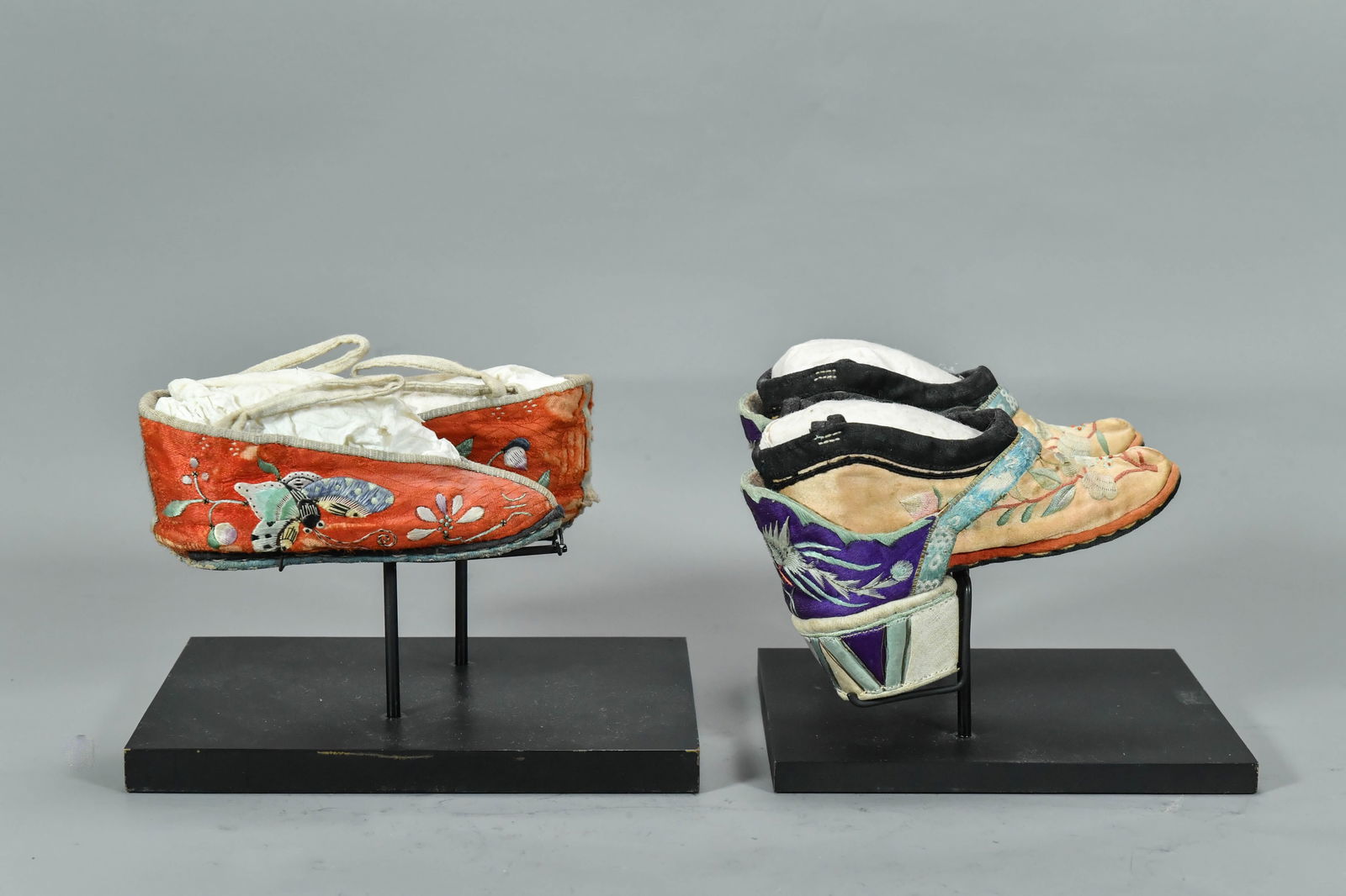 Two Pair of Antique Traditional Chinese Embroidered Lotus Shoes: Two Pair of Antique Traditional Chinese Embroidered Lotus Shoes for Bound Feet w/Display Stand. The high heel shoes with phoenix pattern 6"L x 1"1/2H; The shoes with butterfly pattern 5"1/2L; In good