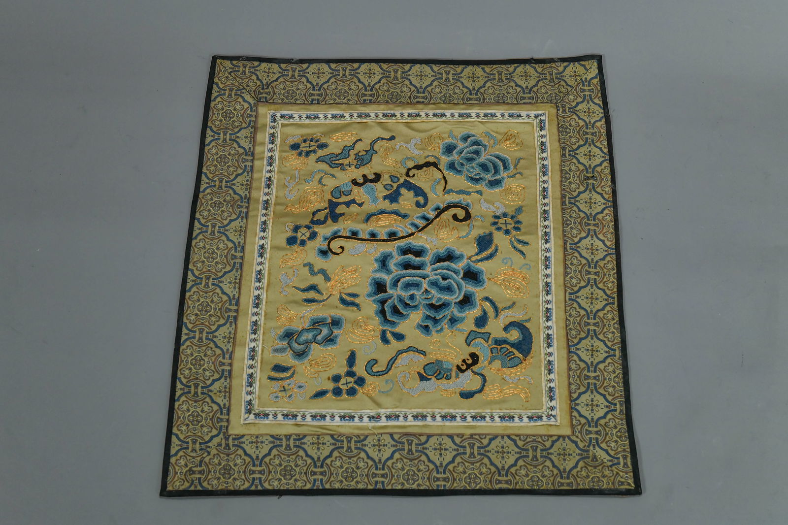 Fine Antique Chinese Square Blue & Gold Silk Embroidered Textile Panel: Fine Antique Chinese Square Blue & Gold Silk Embroidered Textile Panel. 14" x 14". Due to its age, the silk foundation shows areas of darkening, a common characteristic of historic textiles. The embro