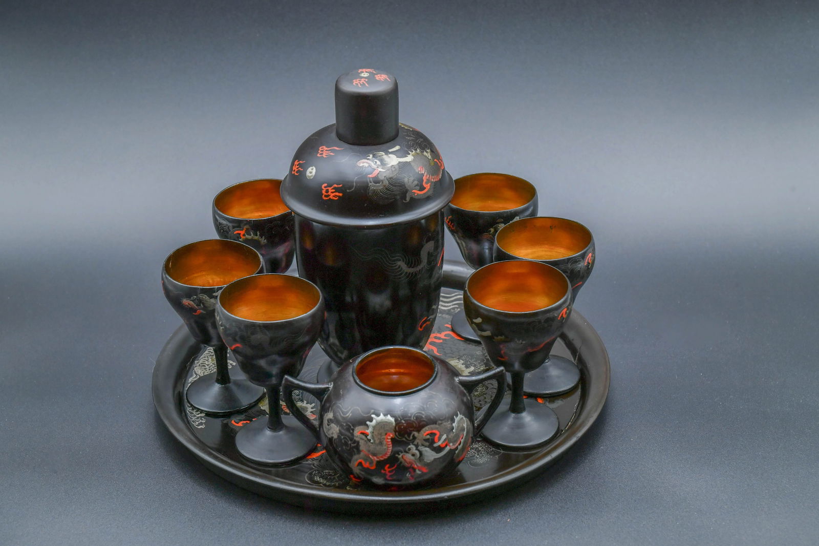 Lot of 9 Vintage Chinese Black Lacquer Cocktail Set w/Dragon Motifs: Lot of 9 Vintage Chinese Black Lacquer Cocktail Set w/Hand-Painted Dragon Motifs. 1)Shaker tall 9"1/2; 2)Tray wide 13"; 3)Sugar bowl 3"H x 5"3/4W; 4)Lot of 6 Goblets, 4"1/2Tall; In good vintage condit