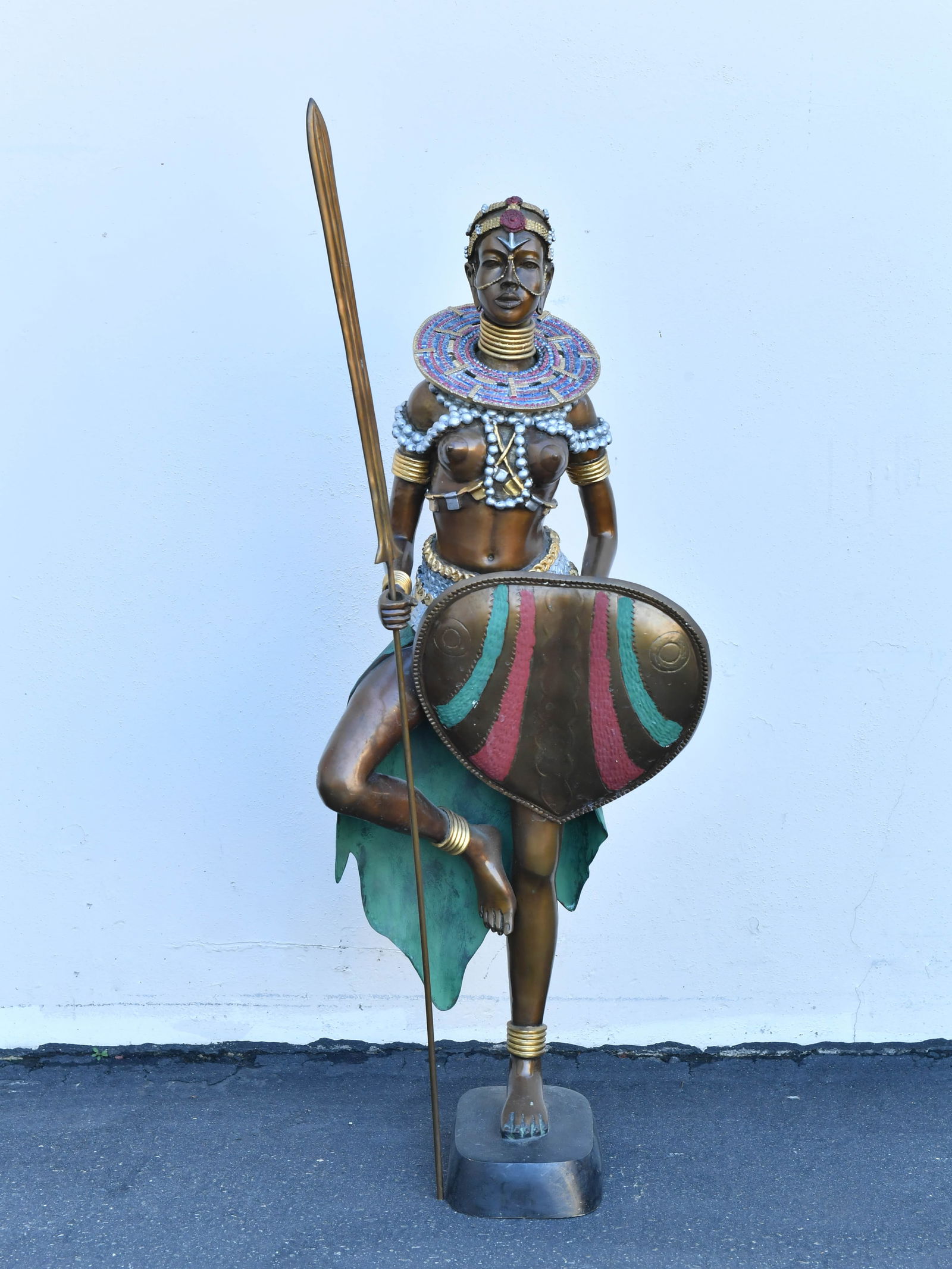 Large Vintage African "Warrior Princess" Bronze Sculpture: Large Vintage African "Warrior Princess" Bronze Sculpture. It is a polychrome cast bronze sculpture, with painted details on the shield and neckpiece. The statue holds a spear and a shield. The figure