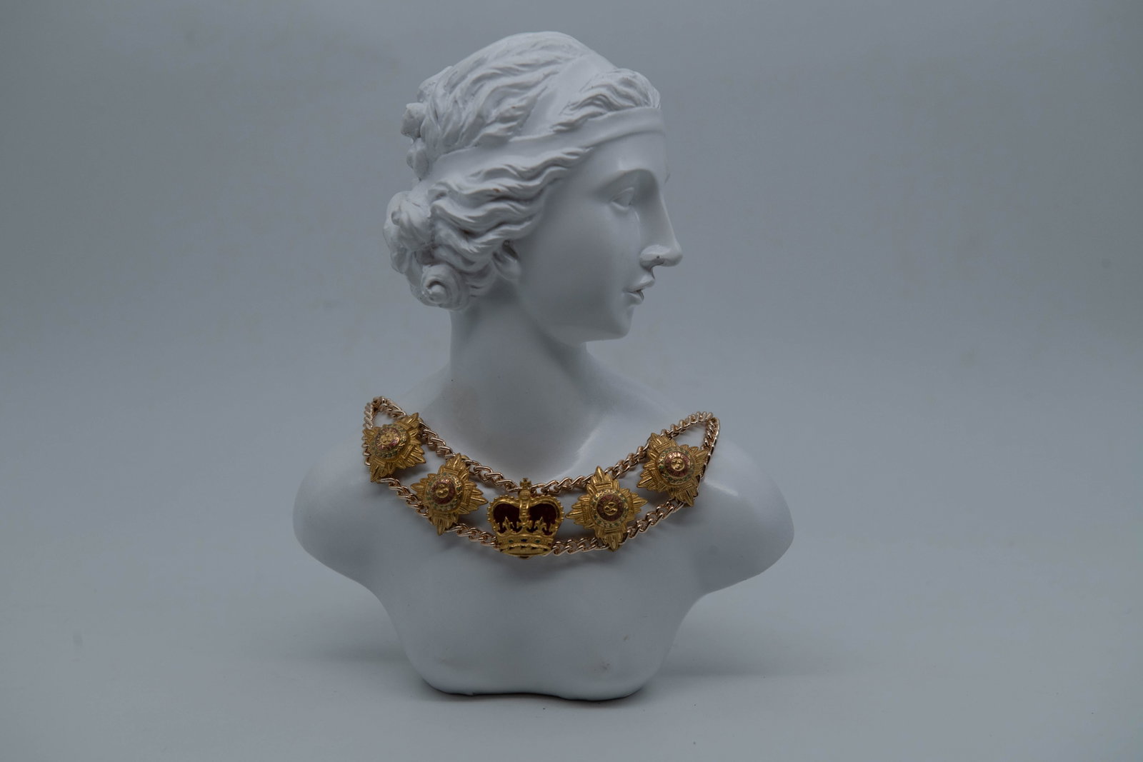 Vintage Gold Tone Dramatic Costume Necklace: Vintage Gold Tone Dramatic Costume Necklace. A central royal crown pendant and shield medallions on a double chain link. Length 14"; In good vintage condition, (Stand Not Included)