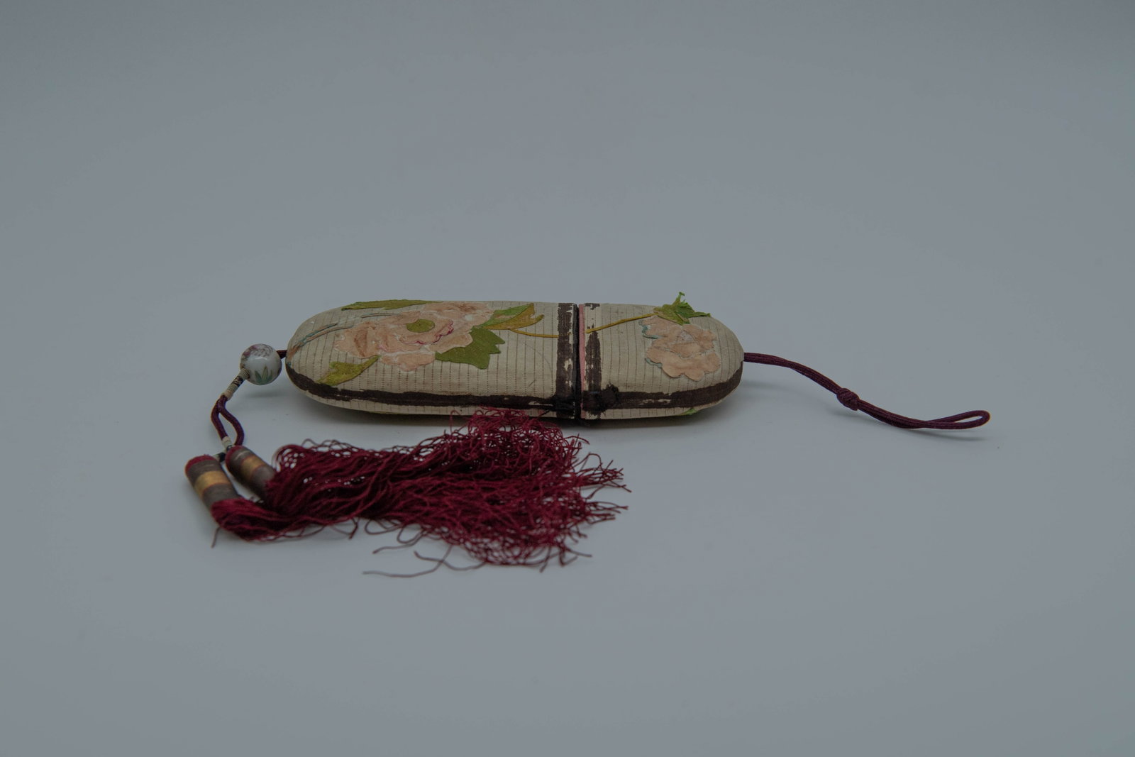 Vintage Chinese Silk Embroidery Eyeglass Case w/A Famille rose Porcelain Bead & Silk Tassels: Vintage Chinese Silk Embroidery Eyeglass Case w/A Famille rose Porcelain Bead & Silk Tassels. Eyeglass case measures 6" x 2"1/2; The silk embroidery showing age-related wear and surface rubbing, consi