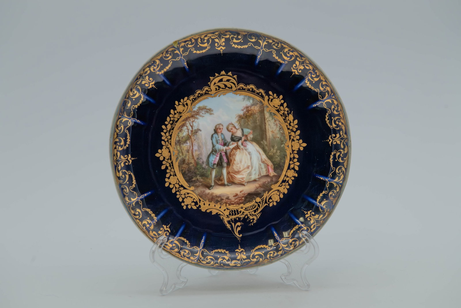 Antique Meissen Deep Cobalt Blue Porcelain Plate w/Hand-Painted Romantic Pastoral Scene: Antique Meissen Deep Cobalt Blue Porcelain Plate w/Hand-Painted Romantic Pastoral Scene. Deep cobalt blue ground with intricate raised gold gilding and a central hand-painted romantic or pastoral scen