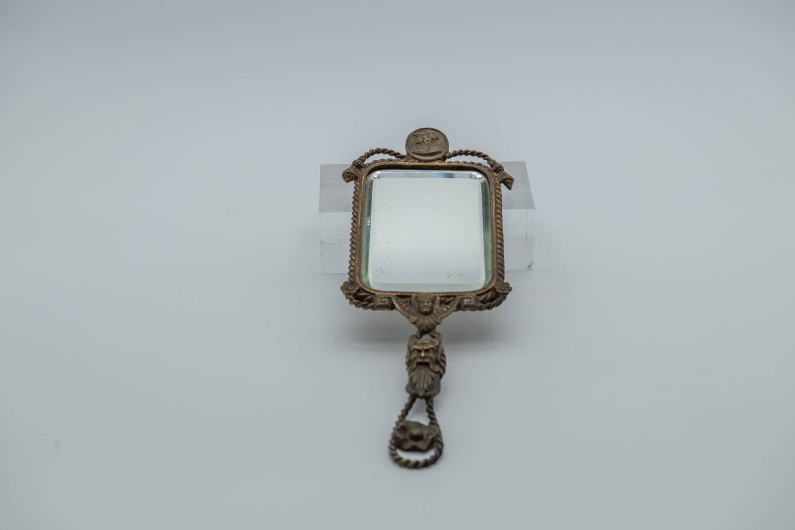1800s Antique Ornate Bronze Handheld Mirror w/Mythological Figures Reliefs: 1800s Antique Ornate Bronze Handheld Mirror w/Mythological Figures Reliefs. Size: 13"L x 4"1/2W; In good overall condition, A beveled glass mirror and may have age-related discoloration or patina.(Sta