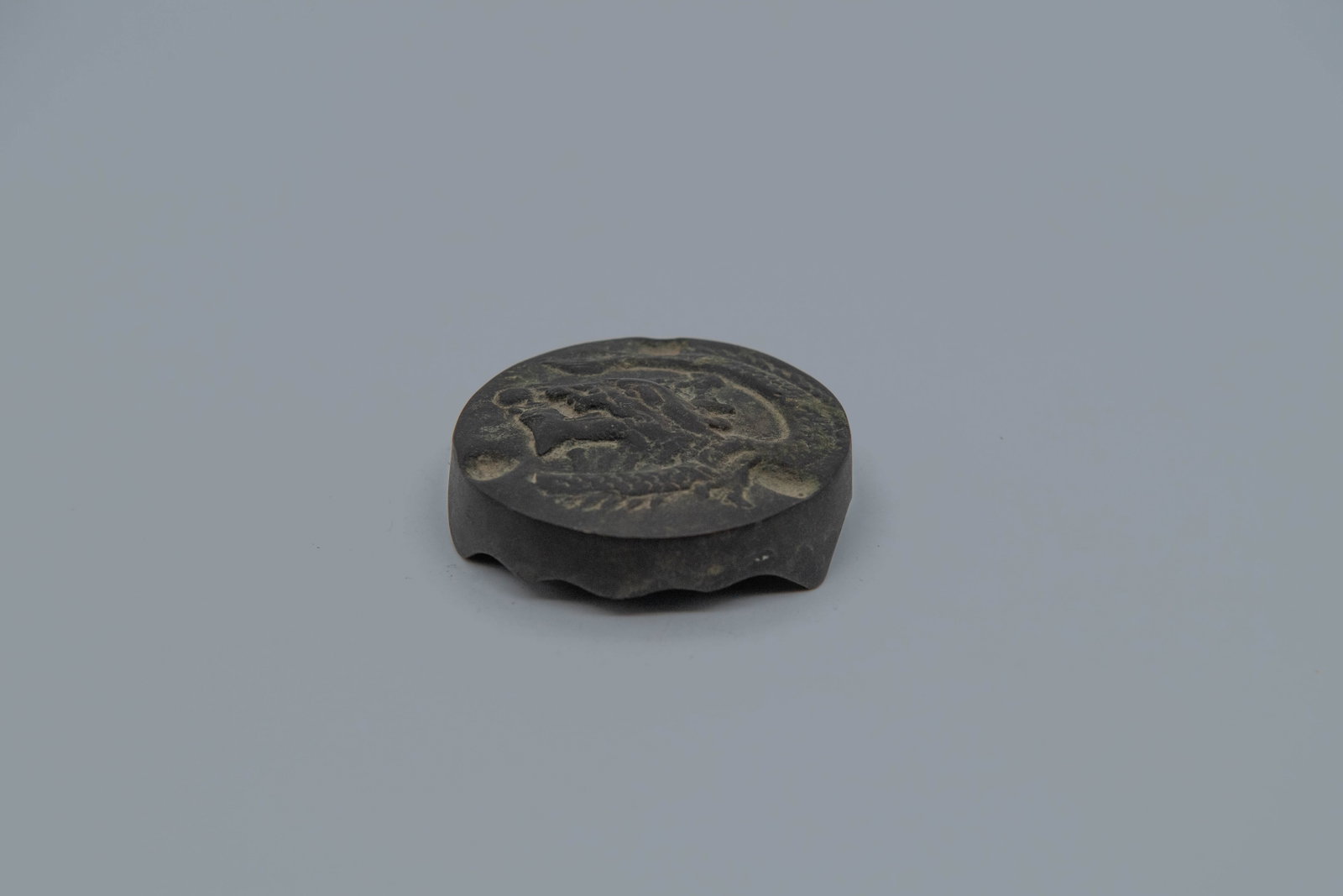 Antique Chinese/Japanese Bronze Circular Artifact w/Relief Dragon Pattern: Antique Chinese/Japanese Bronze Circular Artifact w/Relief Dragon Pattern. Diameter 2"1/2; In good condition, (Stand not Included)