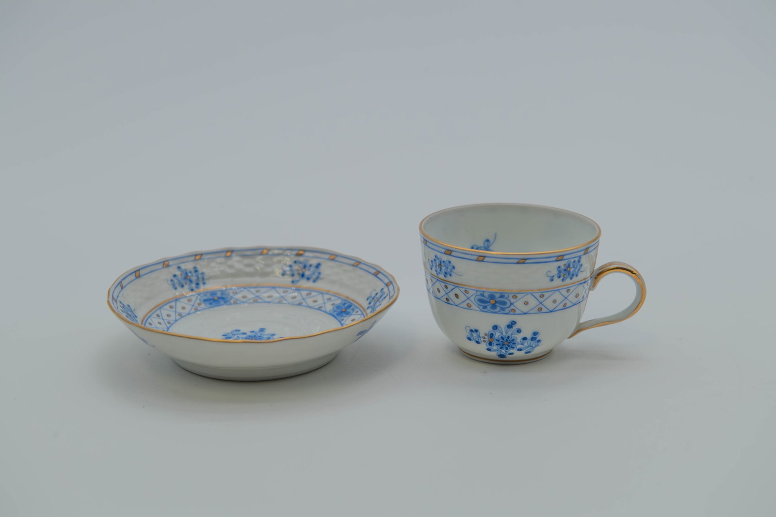 Fine Vintage Herend Hand-Painted Waldstein Blue Porcelain Tea Cup & Saucer Set: Fine Vintage Herend Hand-Painted Waldstein Blue Porcelain Tea Cup & Saucer Set. The Waldstein Blue pattern, with hand-painted blue floral motifs and 24k gold accents trim. Cup size 2"1/2W x 2"H; Sauce