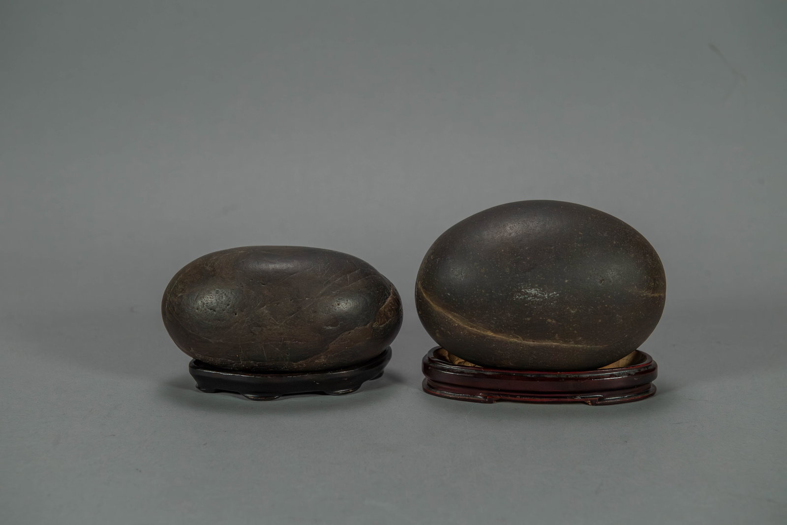Two Natural Egg Shaped Rocks on Stands: Two Natural Egg Shaped Rocks on Stands. Measures approx. 5" x 3"1/2 x 3" and 5"1/2 x 4" x 3"1/2