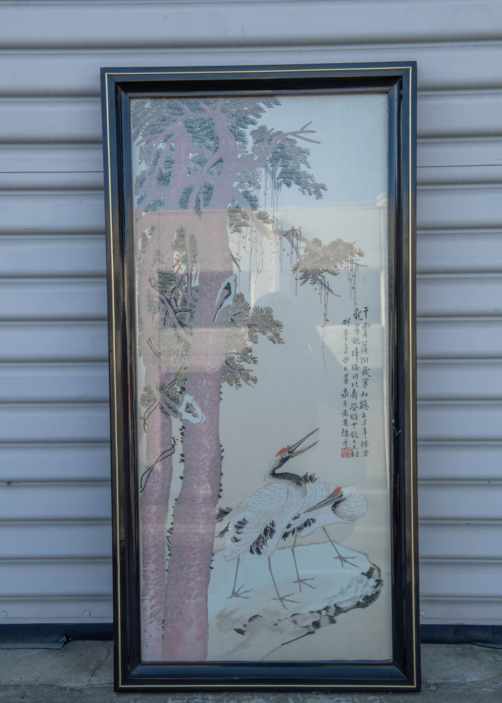 Framed Fine Chinese Silk Embroidered Panel w/Calligraphy & Red Artist Mark: Framed Fine Chinese Silk Embroidered Panel w/Calligraphy & Red Artist Seal Mark. This artwork depicts a crane standing beside a large pine tree, In Asian art to represent longevity. Frame size: 19"3/4