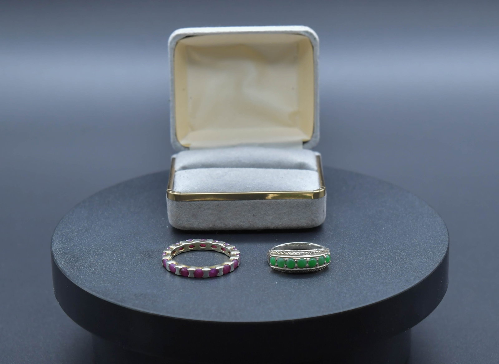Two Vintage Sterling Silver Rings w/Multiple Green Jadeite & Ruby Inlay: Two Vintage Sterling Silver Rings w/Multiple Green Jadeite & Ruby Inlay. 1)A filigree-detailed silver (Silver tested positive by acid test; purity not verified) ring with jadeite stone, US size 6.5, T