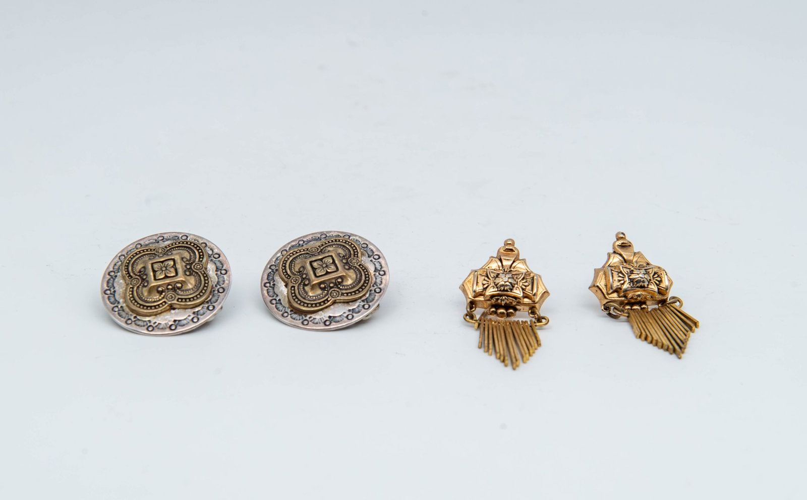Two Set Vintage Gold & Silver Toned Clip-On & Screw-Back Earrings: Two Set Vintage Gold & Silver Toned Clip-On & Screw-Back Earrings. 1)Marked Coro gold plated earrings with distinctive swinging fringe dangles. 1"3/4 x 7/8", Screw-back. 2)Unmarked vintage clip-on and
