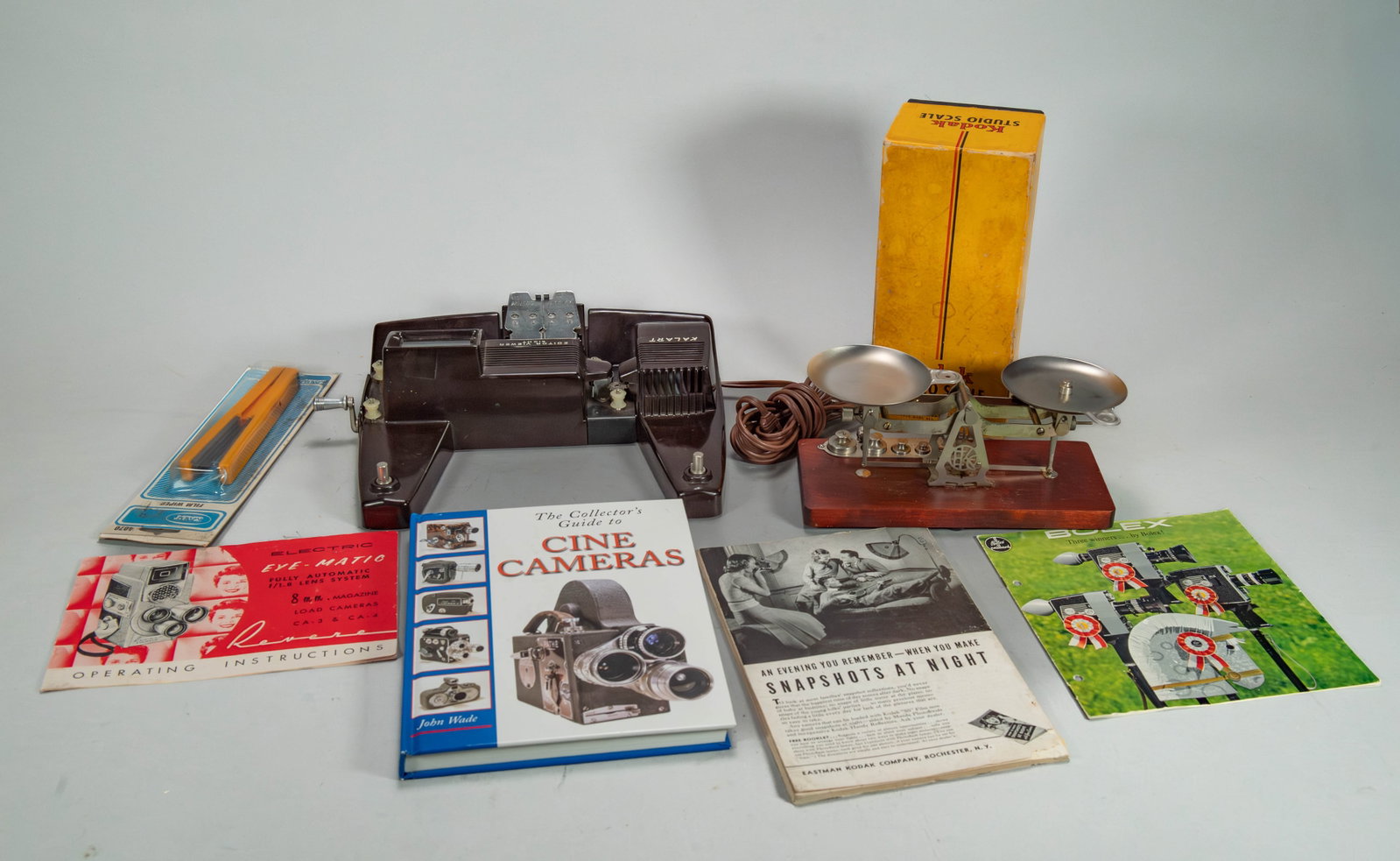 Group of Vintage Film Equipment & Collector's Guide: Group of Vintage Film Equipment & Collector's Guide. 1)Kodak Studio Scale, Made in Rochester, N.Y. USA by Eastman Kodak Company. 9" x 4" x 4". 2)Kalart Editor Viewer Eight 8mm. 11" x 9"1/2 x 2"1/2, Ma