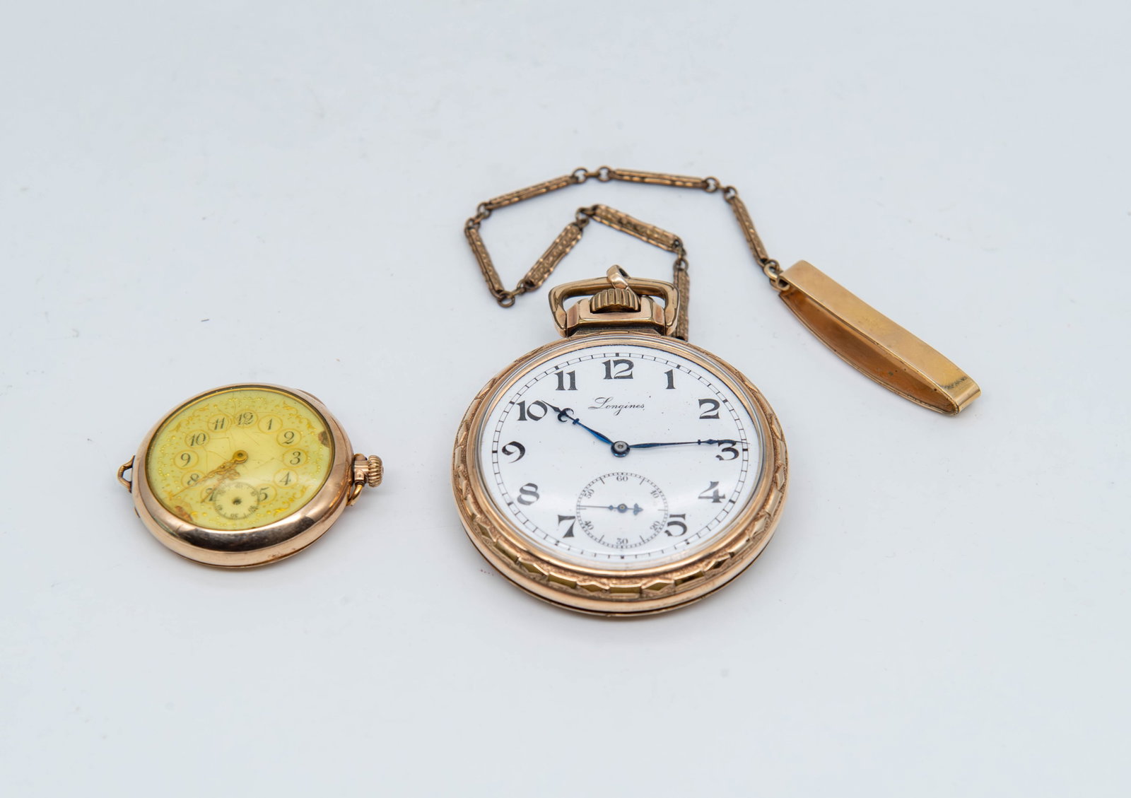 Lot of 2 Vintage Gold-Tone Pocket Watch w/Intricate Engraving "FAHYS" & "LONGINES": Lot of 2 Vintage Gold-Tone Pocket Watch w/Intricate Engraving. 1)Fahys pocket watch, American Waltham Watch Co., #14995782; 1"1/4 Diameter; 2)Longines pocket watch with chain, XMAS 1936; 2" Diameter. 