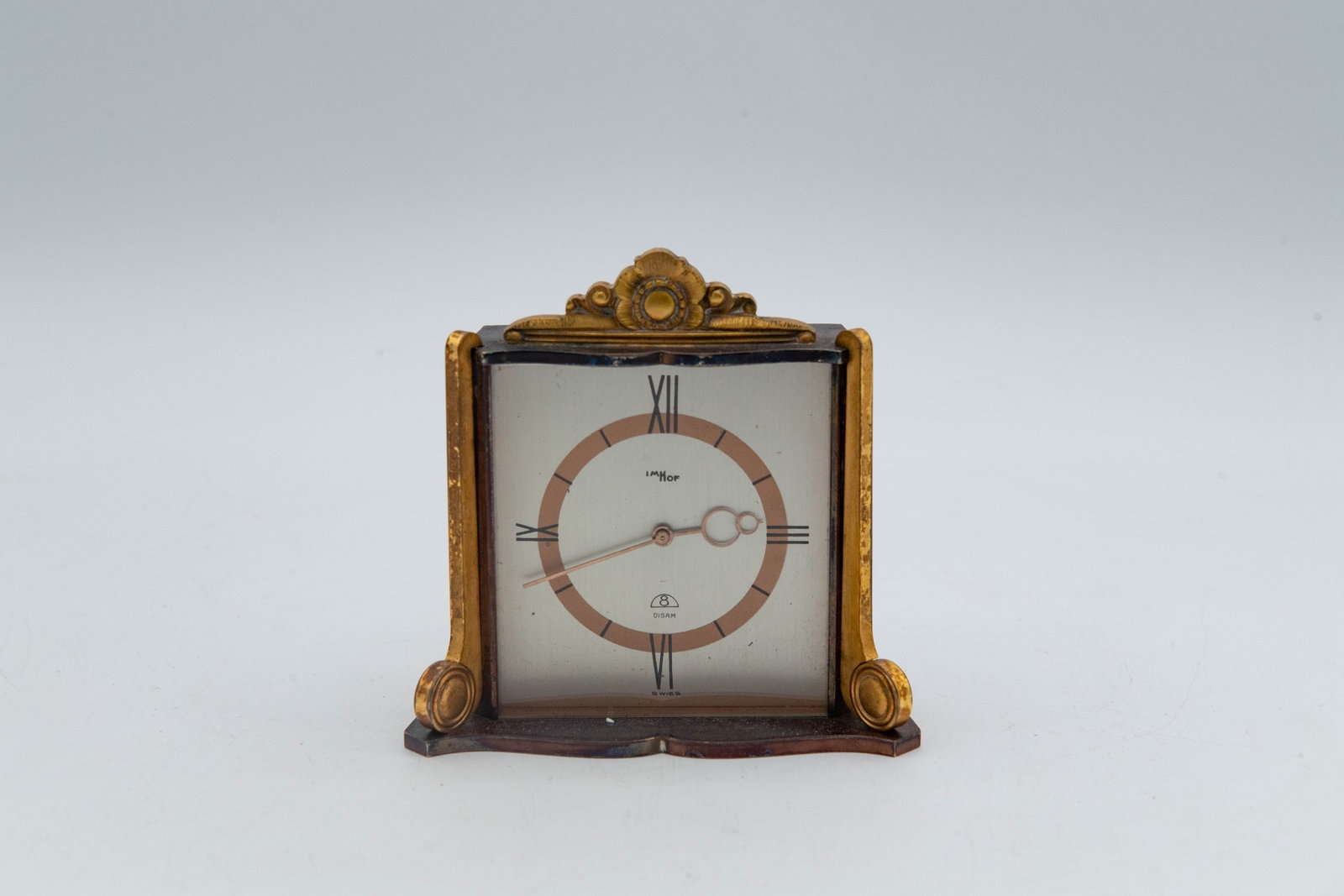 Vintage Imhof Table Clock, 15 Jewels, # 636190, Swiss: Vintage Imhof Table Clock, 15 Jewels, # 636190, Swiss. This vintage clock features a distinctive brass casing with a gold-toned flower decoration at the top. Overall in good vintage condition, the bra