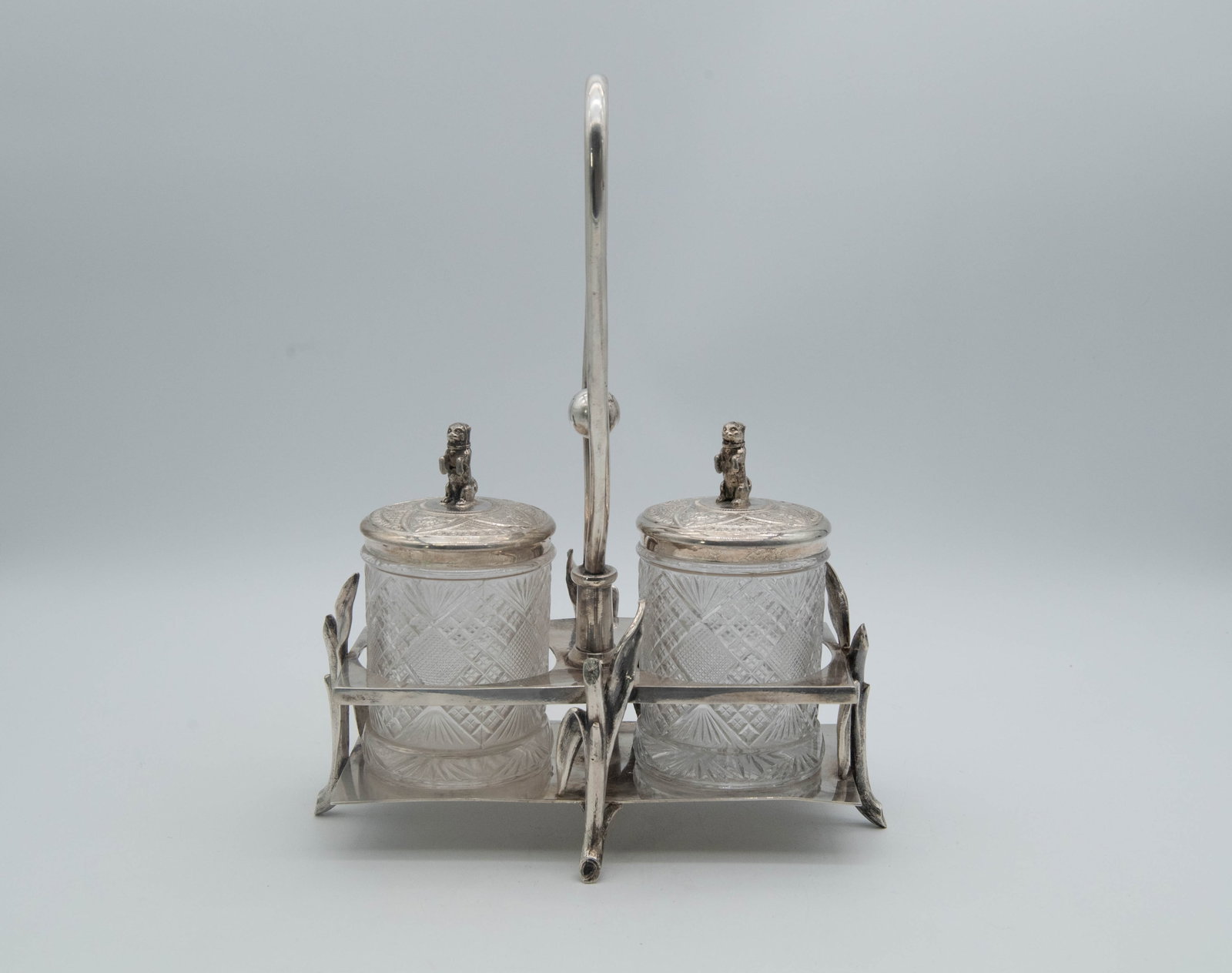 Vintage "ROGERS & BR.O."Silver-plated TRIPLE PIATE Condiment Set: Vintage ROGERS & BR.O. TRIPLE PIATE Condiment Set. Cut glass jars housed within an ornate silver-plated stand/lids, and small dogs figural on the lids. 1)Stand size 10"L x 5"W x 13"H. 2)Jars size 5"3/
