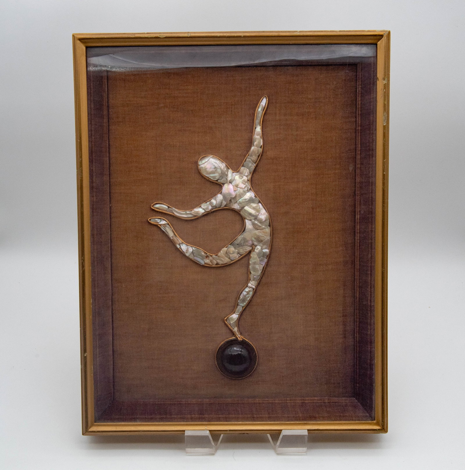 Framed Artisan-Made Wall Art - A MOP Made Mosaic Dancer Figurine: Framed Artisan-Made Wall Art - A MOP Made Mosaic Dancer Figurine. The figurine is constructed from pieces of mother-of-pearl, gold-toned frame, set with a dark and polished sphere at its base. Frame s