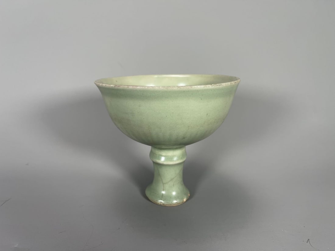 Old Chinese Longquan Celadon-Glazed Porcelain Tall Foot Stem Bowl: Old Chinese Longquan Celadon-Glazed Porcelain Tall Foot Stem Bowl. Tall 4"3/4 and Wide 5"; Small chip at the rim, and crack line on the foot bottom.