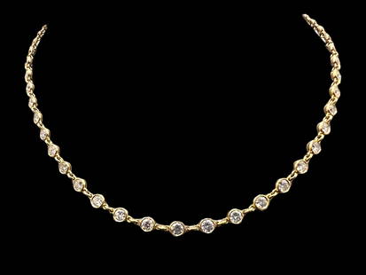 Tiffany & Co. Elsa Peretti Diamonds by the Yard Continuous Necklace in 18k Yellow Gold: A reinvention of the classic diamond necklace, the Elsa Peretti? Diamonds by the Yard collection features bezel-set stones that shimmer against the skin. Continuous round brilliant diamonds set in