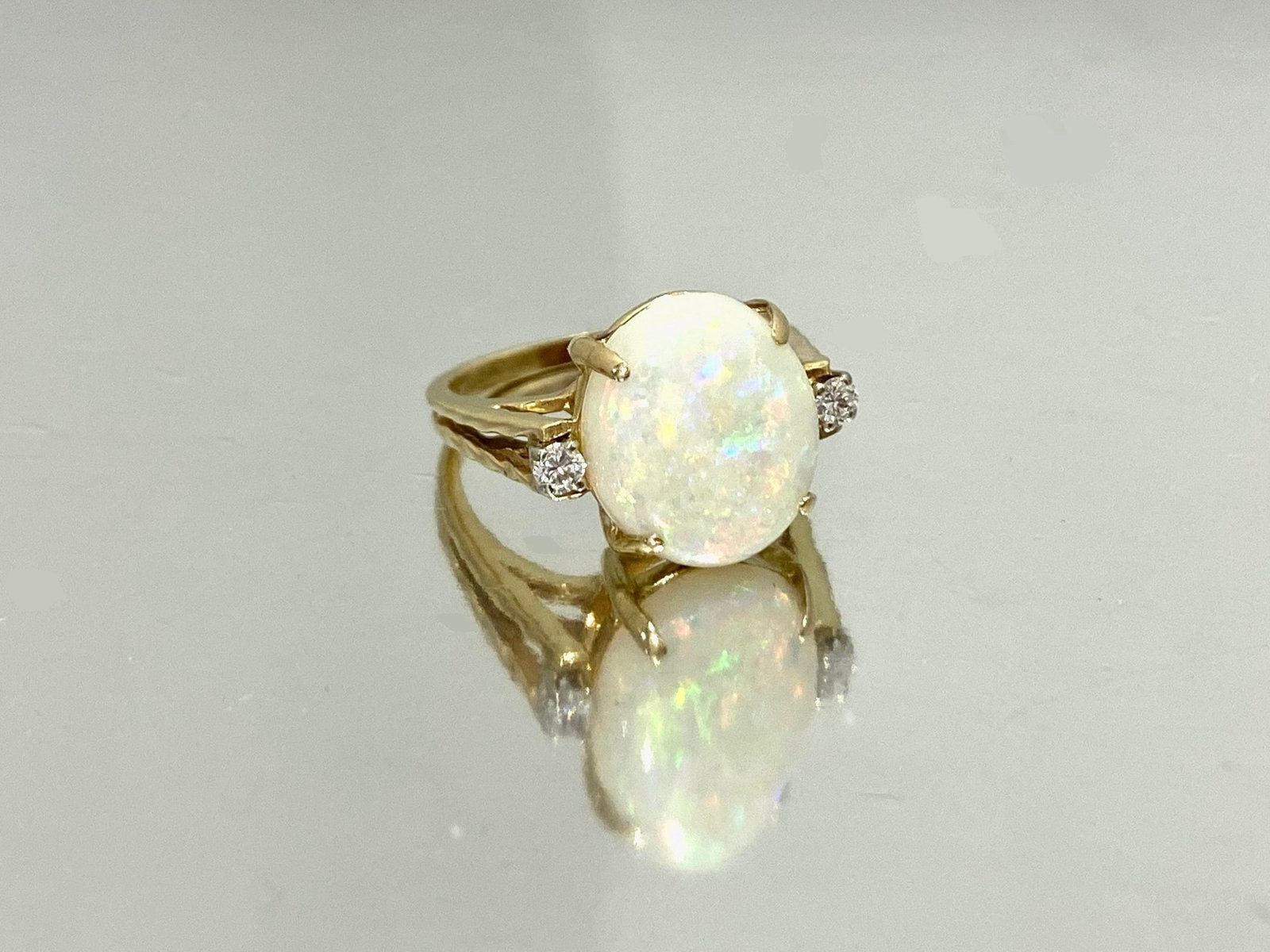 14 Karat Yellow Gold Diamond and Opal Birthstone Ring, Weight: 5.3 grams: Celebrate the elegance of timeless beauty with this exquisite 14 Karat Yellow Gold Diamond and Opal Birthstone Ring. This pre-owned ring is crafted from high-quality 14k yellow gold, showcasing a stun
