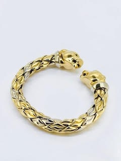 Vintage Chimento Panther Head Cuff Bracelet in 18kt W+YG & Emeralds: From Chimento, this relic 18kt white and yellow gold cuff bracelet demands attention with its powerful and very popular design. Twin Panthers face off wearing collars in 18kt white gold and beaming wi