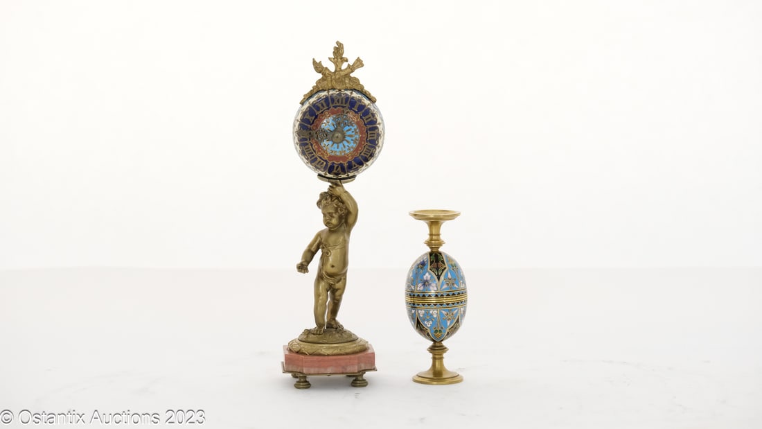 A Small bronze Desk Clock, probably by Barbedienne - France 19th century: A Small bronze Desk Clock on a Pink Marble (H23cm) added joining enamelled Egg Cups (H: 11,5 cm - Probably by Barbedienne - France 19th century H23 W6,0