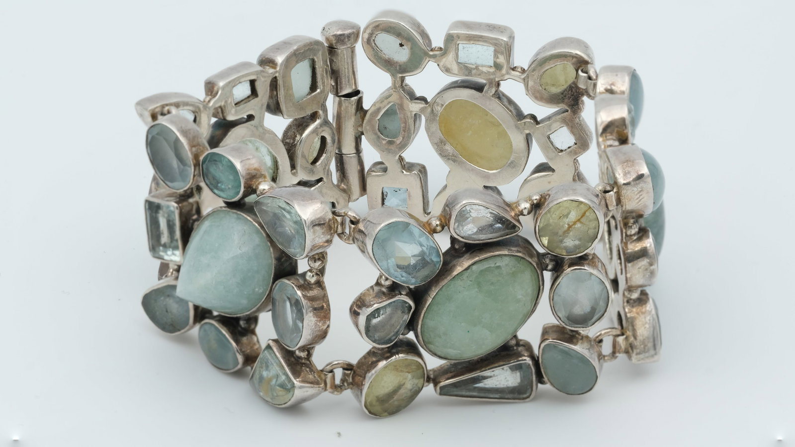 A silver , moonstone and various gemstone bracelet: A silver , moonstone and various gemstone bracelet 3cm wide 19cm wrist 1970's