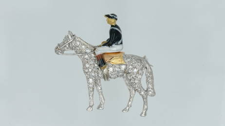 An 18 ct gold, diamond and enamel jockey on horseback - brooch