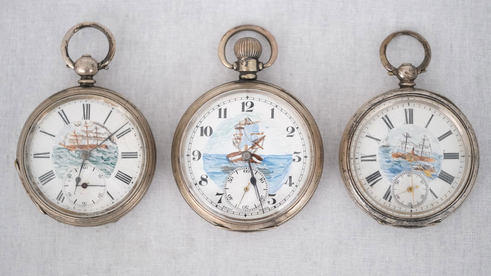 A lot of three Anonymous Antique Silver Pocketwatches with handpainted enamel boat decorations. (1 of 11)