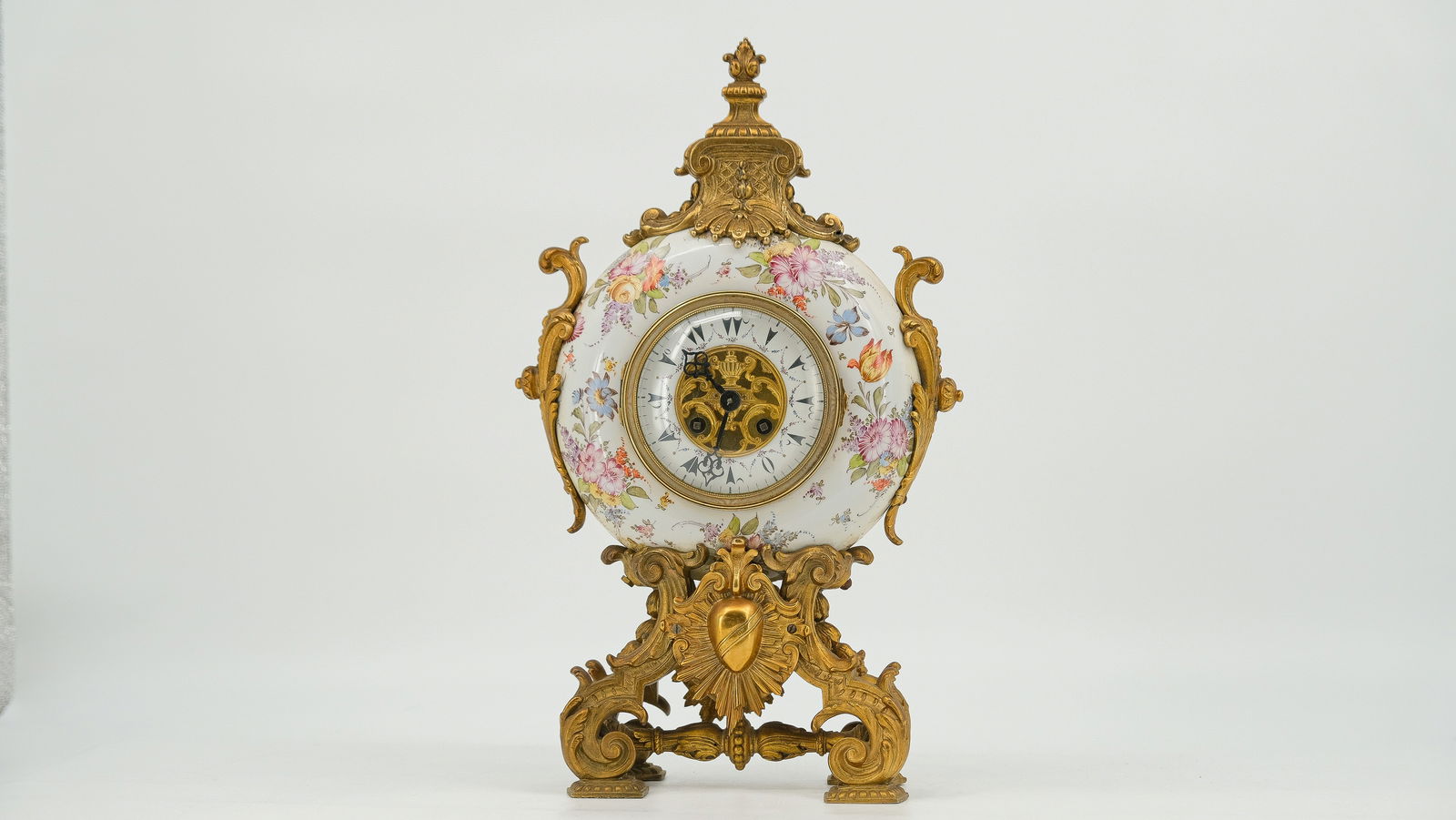 An Antique floral decorated porcelain and gilt bronze mounted mantle clock. (1 of 10)
