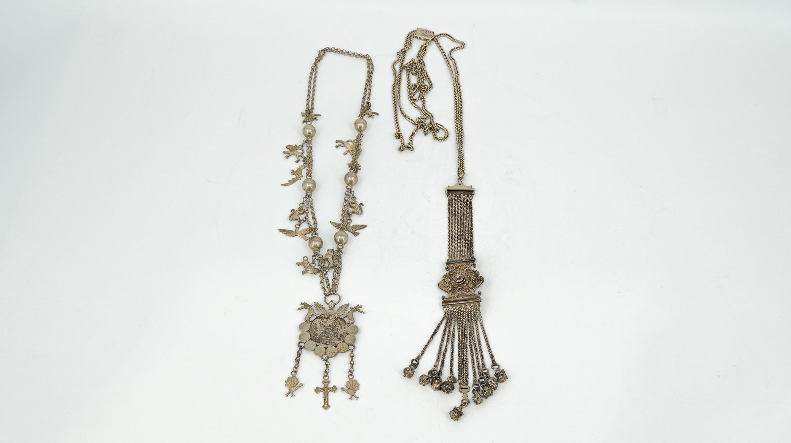 A lot of two antique large silver Guate Malan Ottoman style decorated chatelaines: A lot of two antique large silver Guate Malan Ottoman style decorated chatelaines. Added one tribal necklace and one belt, probably India. 19th/20th century. Total weight: 377 g