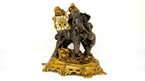 An imposing French antique two colored patinated bronze mantle clock with an Oriental elephant scene