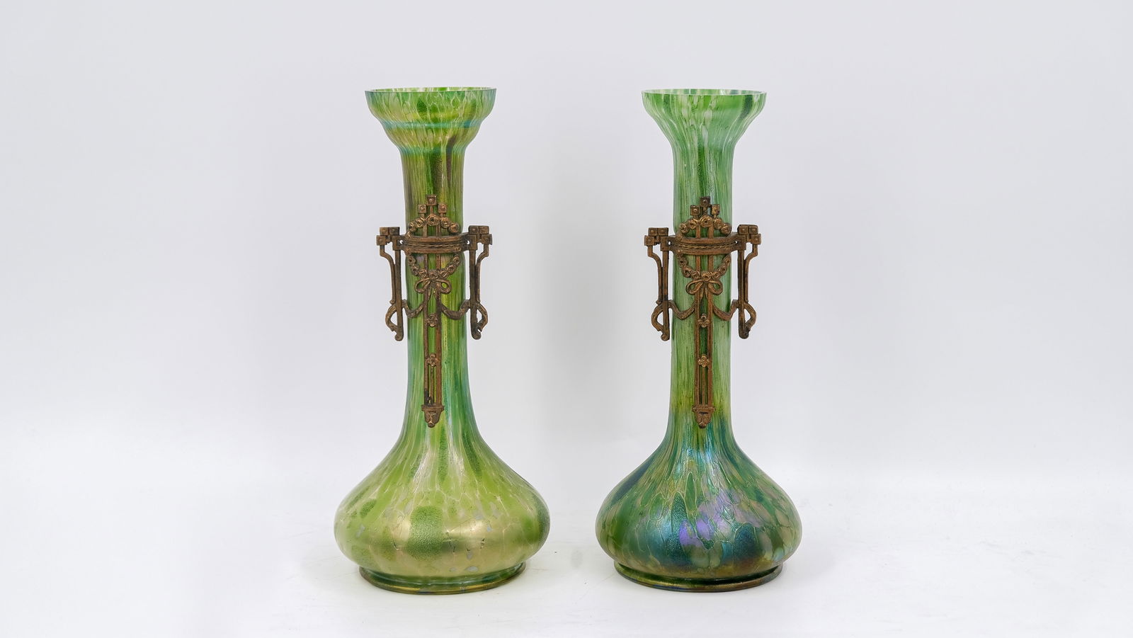 An Art Nouveau style pair of gilt brass mounted glass vases, in the manner Johann LOETZ (1836-1947): An Art Nouveau style pair of gilt brass-mounted glass vases, in the manner of Johann LOETZ (1836-1947) probably Fritz Heckert, Austria. Early 20th century. H: 32 cm