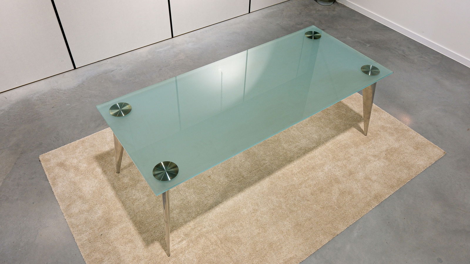 Philippe STARCK - A glass and chromed legs "M" Driade/Aleph dining table: Philippe Starck - A glass and chrome-legged "M" Driade/Aleph dining table. Marked and labelled. Italy, circa 1980s. W: 209 cm - H: 72 cm - D: 90 cm