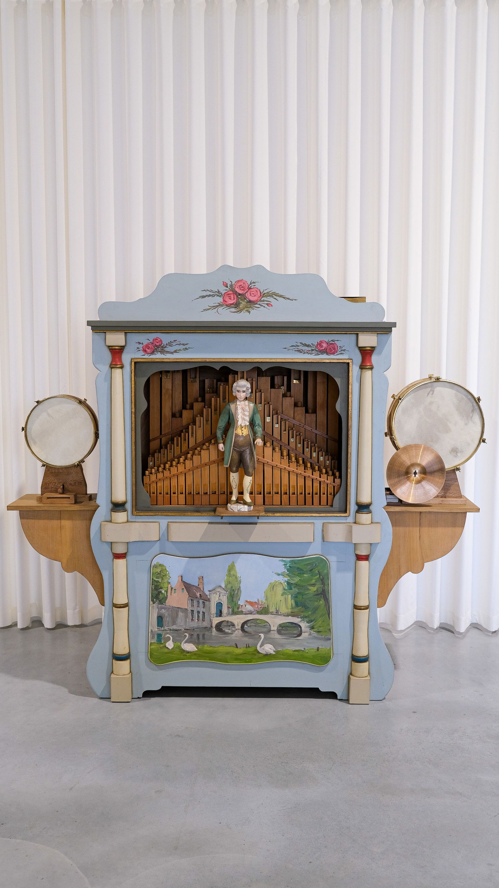 An important and large musical organ with musical card books and carved wooden decoration: An important and large musical organ with musical card books and a carved wooden figure, featuring hand-painted and carved wood decoration. In automatic and playing condition. Probably Belgian-made, c
