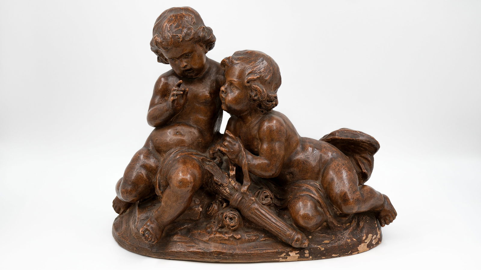 An antique patinated terra cotta figural group of two sitting children circa 1900. (1 of 10)